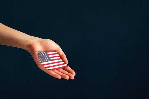 Hand presenting against blue background