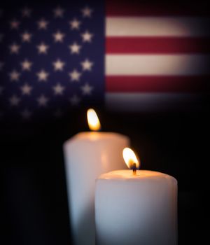 Usa national flag against blazing candles