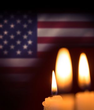 Candles soft light against digitally generated american national flag
