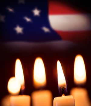 Candles in the dark against highly detailed 3d render of an american flag