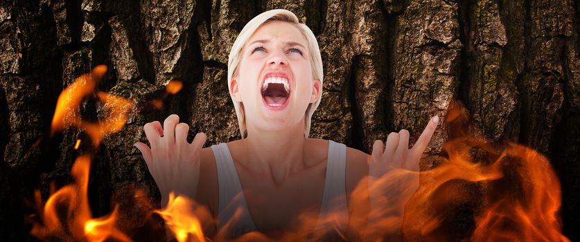 Upset woman screaming with hands up  against brown rough bark