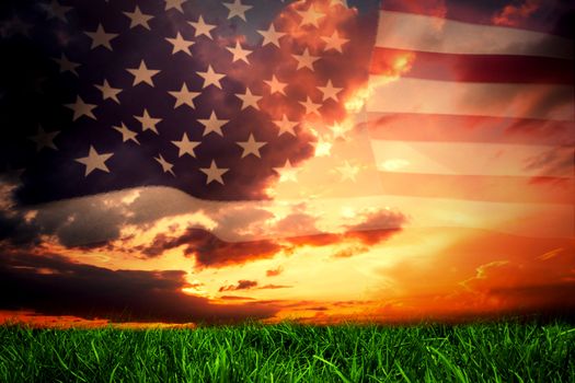 United states of america flag against green grass under dark blue and orange sky