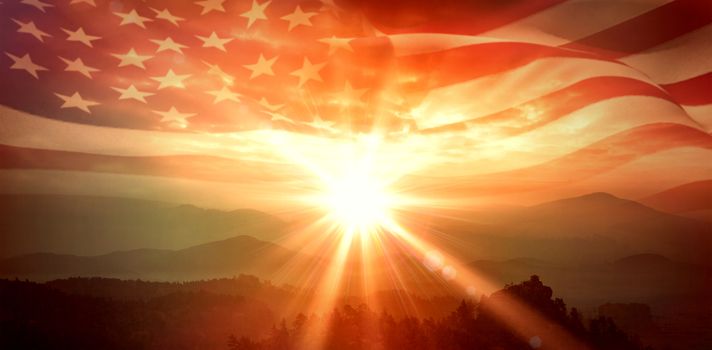Digitally generated american flag rippling against sunrise over mountains