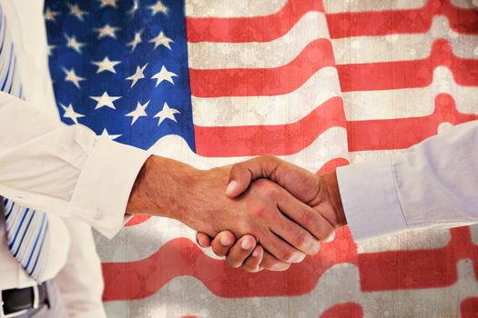 Close-up shot of a handshake in office against paint splattered paper