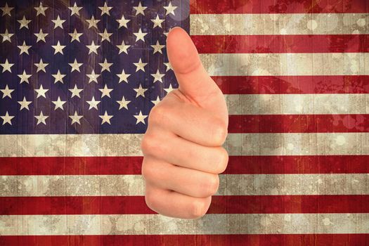 Hand showing thumbs up against usa flag in grunge effect