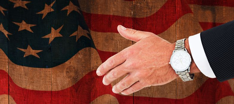 Businessman in suit clenching fists against weathered oak floor boards background