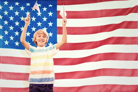 Cute boy with american flag against rippled us flag