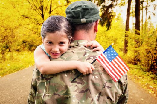 Soldier reunited with his daughter against country road along trees in the lush forest