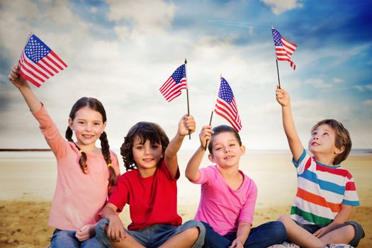 Children with american flags against serene beach landscape