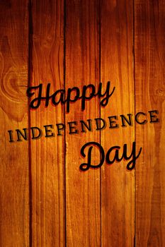Independence day graphic against overhead of wooden planks