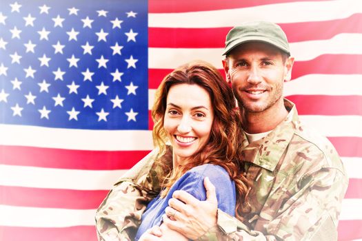 Soldier reunited with partner against rippled us flag