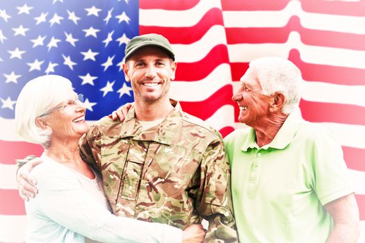 Soldier reunited with parents against rippled us flag