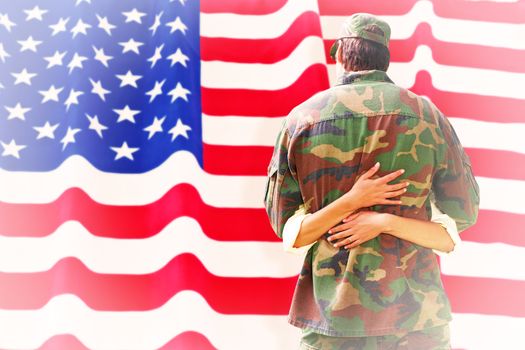 Army wife reunited with husband against rippled us flag