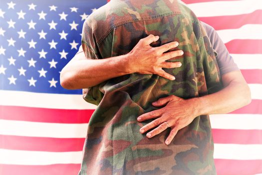Solider reunited with father against rippled us flag