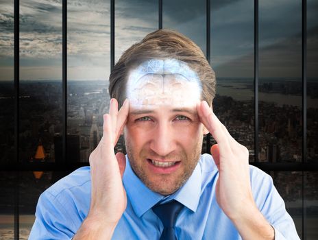 Young businessman with severe headache against room with large window looking on city