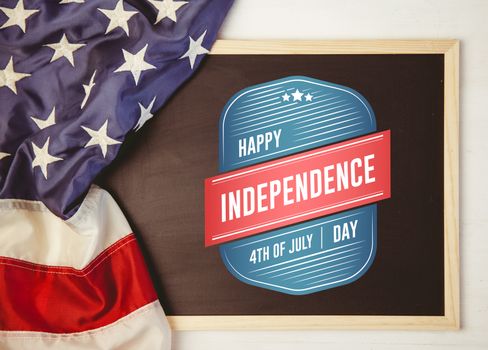 Independence day graphic against american flag on chalkboard