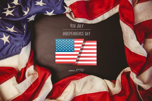 Independence day graphic against american flag on chalkboard