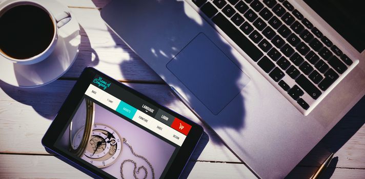website design against tablet on desk with laptop and coffee