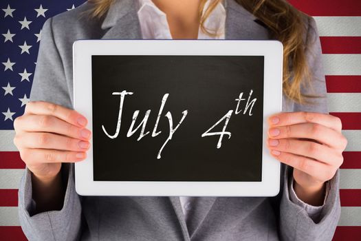 Businesswoman showing tablet against july 4th