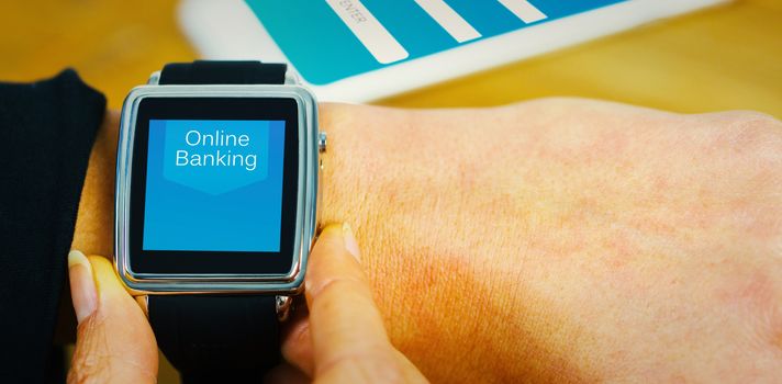 Businesswoman with smart watch on wrist against online banking