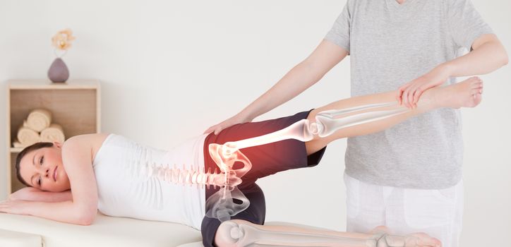 Digital composite of Highlighted bones of woman at physiotherapist 