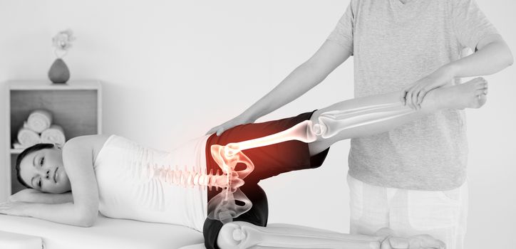 Digital composite of Highlighted bones of woman at physiotherapist 