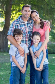 Happy family in the park together on a sunny day