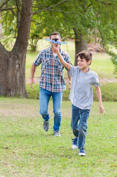 Father and son having fun in the park on a sunny day