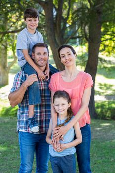 Happy family in the park together on a sunny day