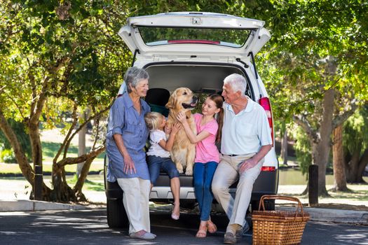 Grandparents going on road trip with grandchildren on a sunny day