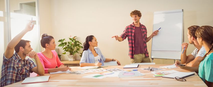 Casual young businessman giving a presentation to his colleagues