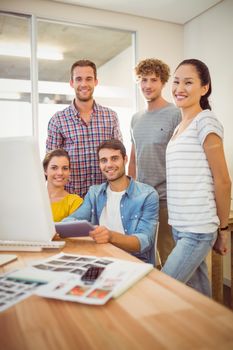 Portrait of gathered creative business team smiling at the camera