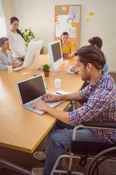 Creative casual businessman in wheelchair in the office