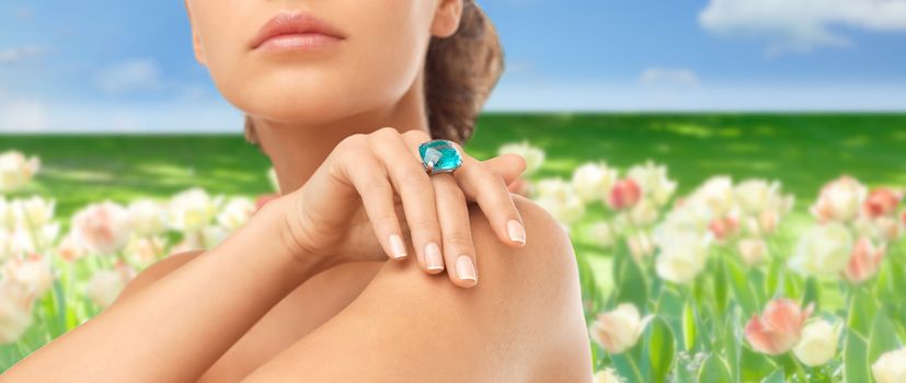 wedding, bridal jewelry and luxury concept - close up of beautiful woman hand with big blue cocktail ring