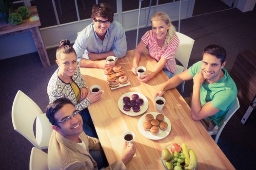 Young business people having dessert after lunch