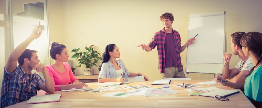 Casual young businessman giving a presentation to his colleagues