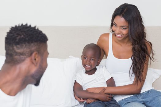 Happy family on the bed at home in bedroom