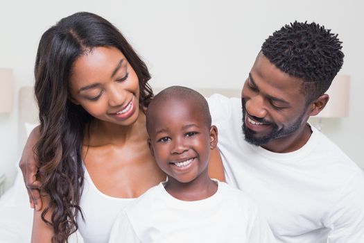 Happy family smiling at each other at home in bedroom