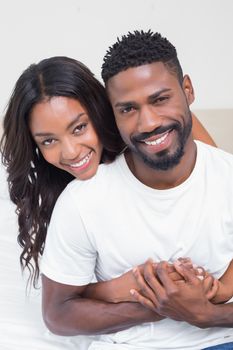 Happy couple spending time together at home in bedroom