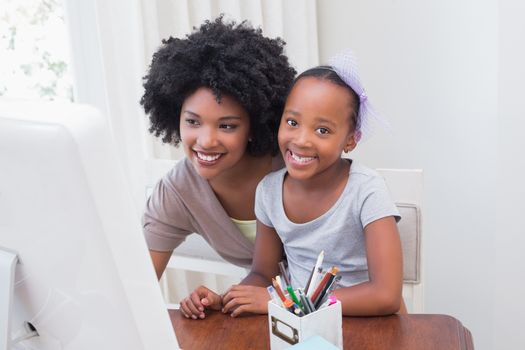 Happy family using the computer at home