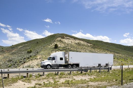 Shot of a big trucks traveling along the highway of the america.