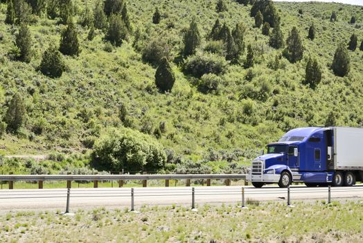 Shot of a big trucks traveling along the highway of the america.