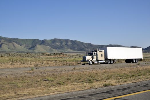 Shot of a big trucks traveling along the highway of the america.