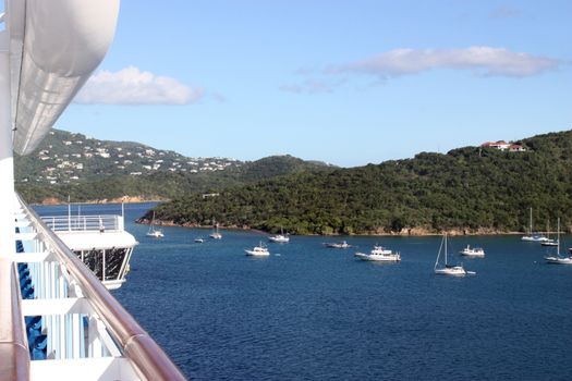 Large cruise ship sailing through tropical island