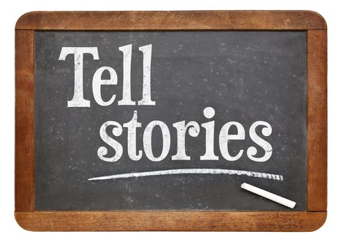 Tell stories advice - text in white chalk on a vintage slate blackboard