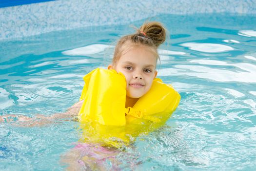 Six year old girl Europeans bathed in a small suburban pool