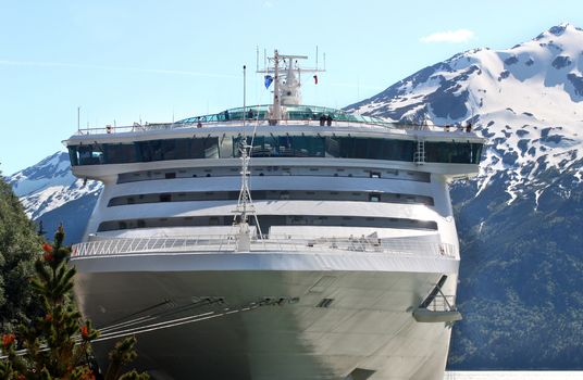 Big cruise ship docked near small port in Alaska