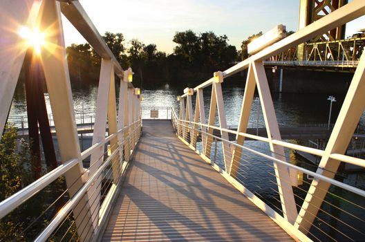 Sunset light by old river bridge