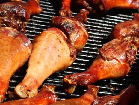 Fresh and juicy turkey legs on open grill
