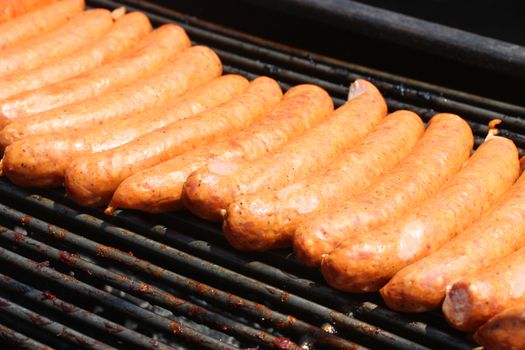 Fresh and juicy hotdogs on open grill